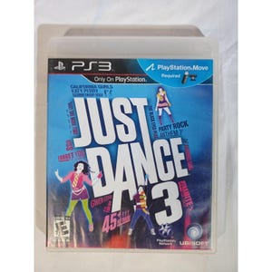 May include: A PlayStation 3 game case for "Just Dance 3." The cover features the game's title in large white letters over a blue background. Graphics of dancers and song titles like "California Gurls" and "Party Rock Anthem" are also visible.