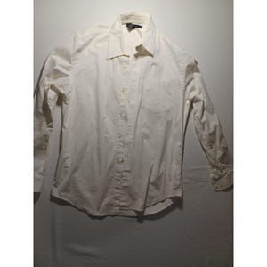 May include: A long-sleeved, off-white button-down shirt with a classic collar and a chest pocket. The shirt is made of a lightweight fabric and features buttoned cuffs. The garment is neatly folded and appears to be in good condition.