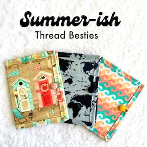 May include: Three rectangular fabric pouches with button closures. The left pouch features beach huts on sand, the center displays a black and white world map, and the right shows a wavy orange and teal pattern. Text reads Summer-ish Thread Besties.