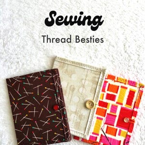 May include: Three rectangular fabric cases with button closures. One is brown with a pin pattern, one is cream with a subtle geometric print, and one features a colorful spool and needle design. The text "Sewing Thread Besties" is visible.