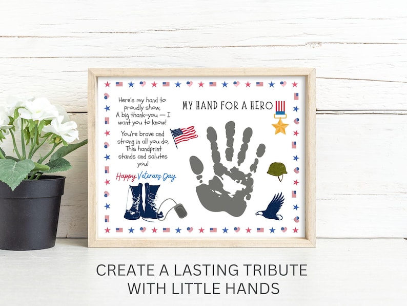 May include: Framed print with the text "MY HAND FOR A HERO" and "Happy Veterans Day". The print features a handprint, an American flag, military boots, a helmet, and an eagle. The phrase "CREATE A LASTING TRIBUTE WITH LITTLE HANDS" is at the bottom.