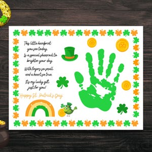May include: A white card with a green handprint, shamrocks, and gold coins. The card has a poem that reads "This little handprint you see today is a special shamrock to brighten your day. With fingers so small and a heart so true. It's my lucky gift just for you! Happy St. Patrick's Day."