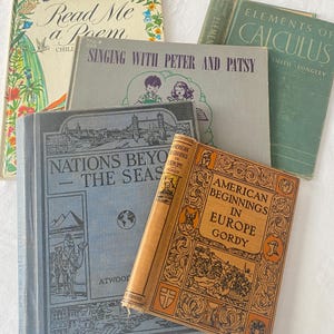 May include: A collection of vintage books with various titles, including "Read Me a Poem," "Singing with Peter and Patsy," and "Nations Beyond the Seas." The books have aged covers in shades of blue, green, and orange, with decorative illustrations and text.