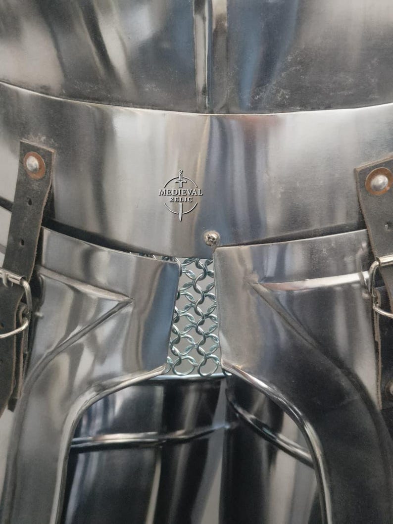 May include: Close-up of polished steel armor with leather straps and buckles. A section of chainmail is visible. The logo "MEDIEVAL RELIC" is stamped on the armor.