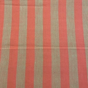 May include: A fabric with alternating stripes of coral and beige. The fabric has a woven texture.