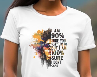 May include: White t-shirt with a colorful graphic of a woman with sunglasses and the text "I am 90% sure you don't like me but I am 100% sure I don't care."