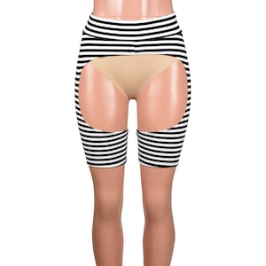 May include: A black and white striped garter belt and thigh high set. The garter belt wraps around the waist and features a series of horizontal black stripes. The thigh highs are also striped and are connected to the garter belt.