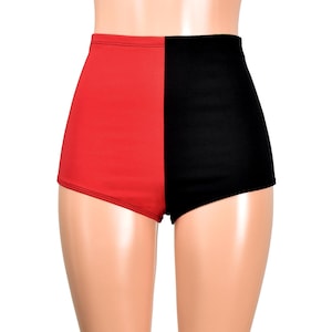 May include: High-waisted shorts featuring a split-color design with a solid red panel on the left side and a solid black panel on the right side. The garment has a smooth, fitted silhouette that extends to the upper thigh with clean seams.