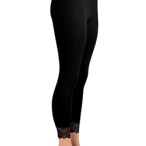 May include: Black leggings with a black lace waistband and lace trim at the bottom of the legs.