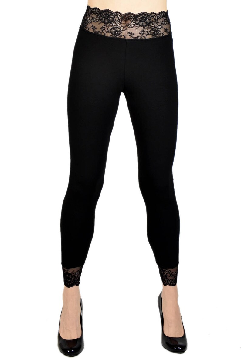 May include: Black leggings with a black lace waistband and lace trim at the bottom of the legs.