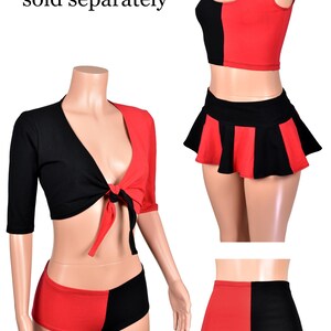 May include: A red and black two-tone clothing set featuring a tie-front crop top with half-length sleeves, a sleeveless tank top, a pleated mini skirt, and high-waisted shorts. The text "Matching items sold separately" is visible in the image.