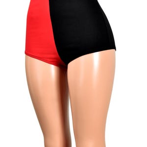 May include: High-waisted shorts featuring a color-blocked design with a solid red panel on the left side and a solid black panel on the right side. The garment has a smooth, fitted silhouette that extends from the waist to the upper thighs.