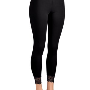 May include: Black leggings with a black lace waistband and lace trim at the ankles.