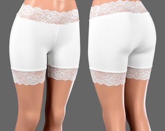 May include: White cotton shorts with a white lace trim around the waistband and leg openings.