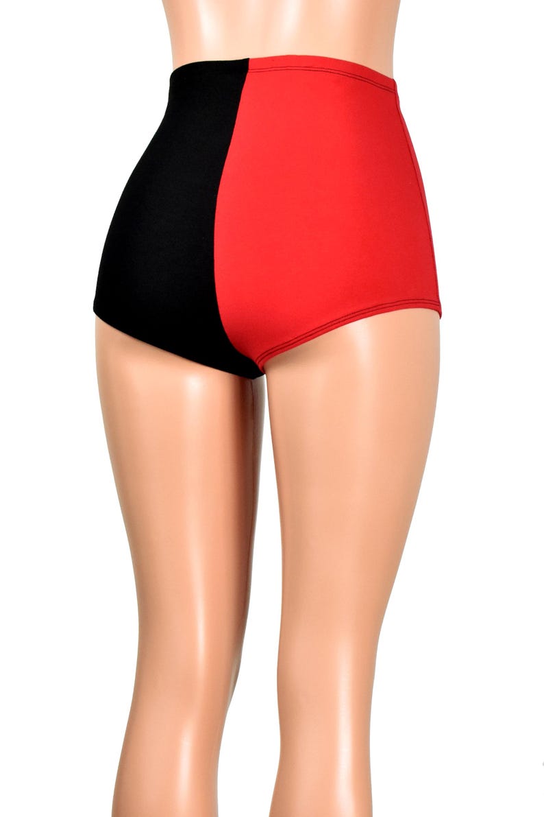 May include: High-waisted shorts featuring a split-color design with a solid black panel on the left side and a solid red panel on the right side. The garment has a smooth, fitted silhouette that covers the upper thighs and sits at the waist.