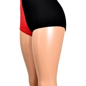 May include: High-waisted underwear featuring a color-blocked design with a solid black panel on the side and a solid red panel on the front. The garment has a smooth, fitted silhouette that extends from the waist down to the upper thigh area.