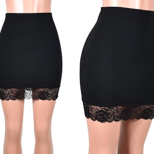 May include: Black mini skirt with a lace trim. The skirt is made of a stretchy fabric and has a fitted silhouette.