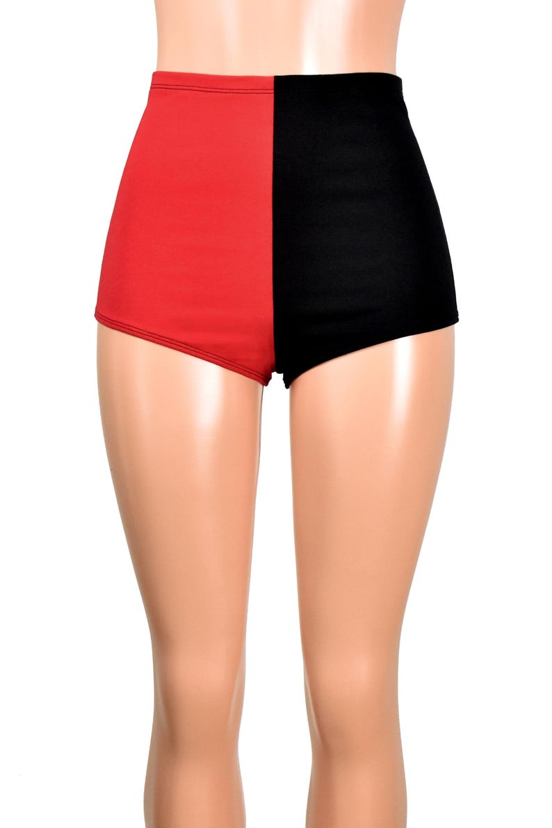 May include: High-waisted shorts featuring a split-color design with a solid red panel on the left side and a solid black panel on the right side. The garment has a smooth, fitted silhouette that extends to the upper thigh with clean seams.