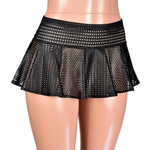 May include: Black mini skirt with a mesh design. The skirt has a pleated, flared silhouette and a wide waistband. The mesh fabric allows for a glimpse of the skin beneath. The skirt is designed to be worn at the waist.