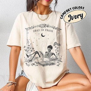 Read in Peace Skeleton Reading Book Halloween Bookish T-Shirt Spooky Fall Unisex Tee Perfect for Book Lovers