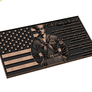 May include: A wooden plaque with a black and brown American flag and a sailor in uniform. The plaque has the text "The Sailor's Creed" and a poem about the creed.
