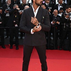 Elegant men’s custom pinstripe double breasted suit with peak lapels, tailored fit blazer, and matching trousers, designed for weddings, business, and red carpet events.