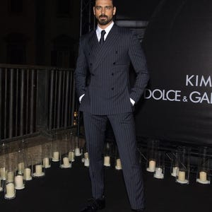 Elegant men’s custom pinstripe double breasted suit with peak lapels, tailored fit blazer, and matching trousers, designed for weddings, business, and red carpet events.