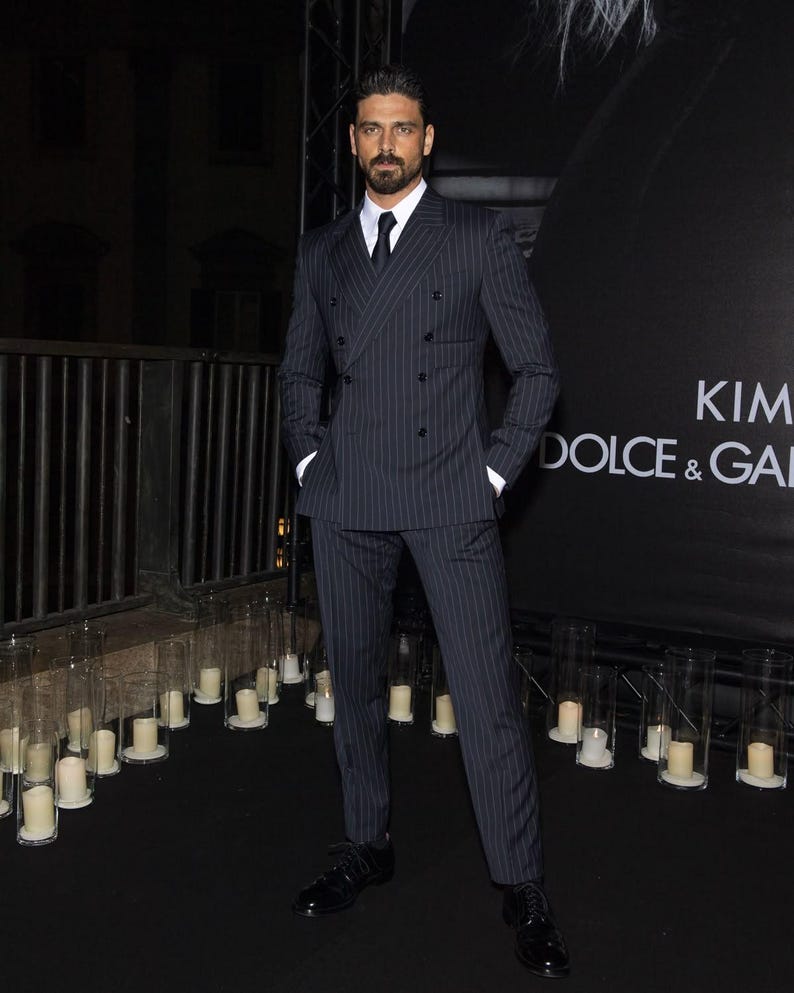 Elegant men’s custom pinstripe double breasted suit with peak lapels, tailored fit blazer, and matching trousers, designed for weddings, business, and red carpet events.