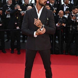 Elegant men’s custom pinstripe double breasted suit with peak lapels, tailored fit blazer, and matching trousers, designed for weddings, business, and red carpet events.