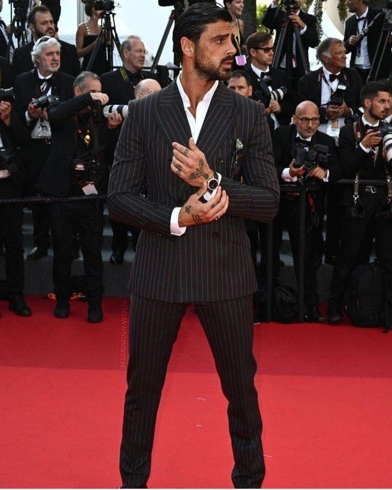 Elegant men’s custom pinstripe double breasted suit with peak lapels, tailored fit blazer, and matching trousers, designed for weddings, business, and red carpet events.