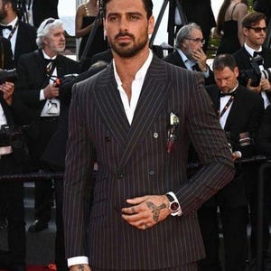 Elegant men’s custom pinstripe double breasted suit with peak lapels, tailored fit blazer, and matching trousers, designed for weddings, business, and red carpet events.