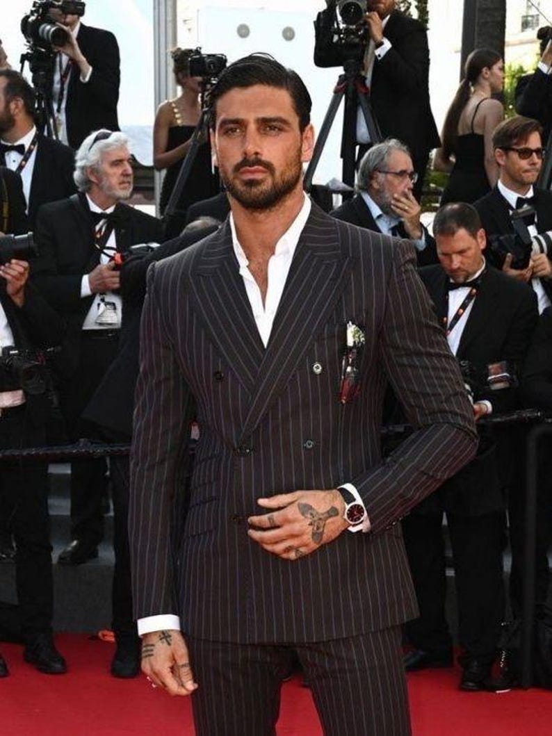 Elegant men’s custom pinstripe double breasted suit with peak lapels, tailored fit blazer, and matching trousers, designed for weddings, business, and red carpet events.