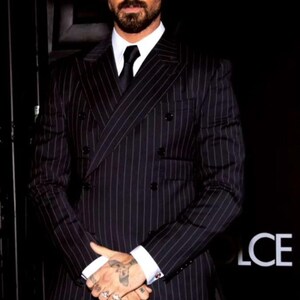 Elegant men’s custom pinstripe double breasted suit with peak lapels, tailored fit blazer, and matching trousers, designed for weddings, business, and red carpet events.