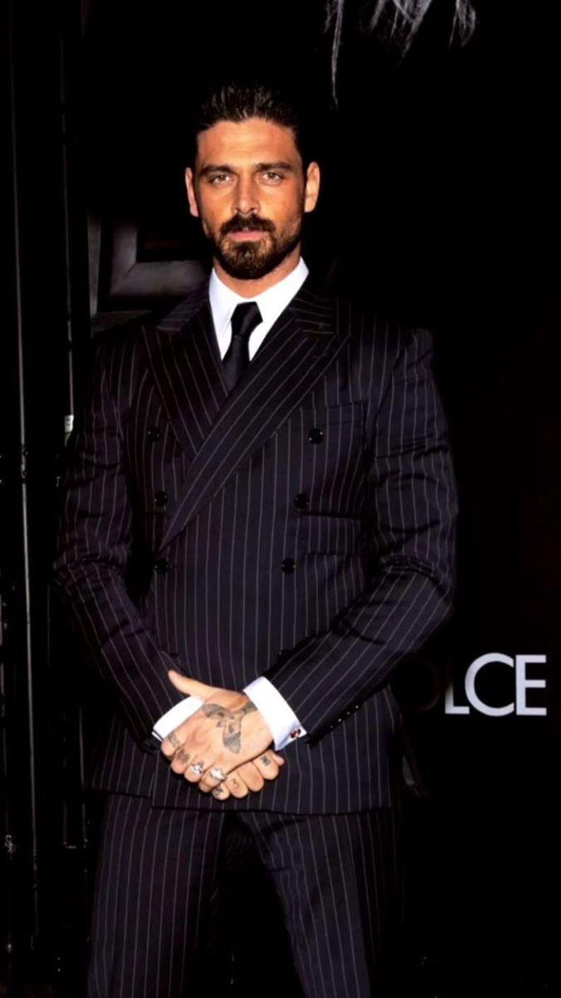 Elegant men’s custom pinstripe double breasted suit with peak lapels, tailored fit blazer, and matching trousers, designed for weddings, business, and red carpet events.