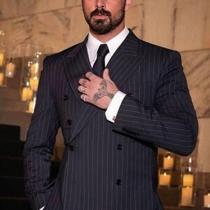 Elegant men’s custom pinstripe double breasted suit with peak lapels, tailored fit blazer, and matching trousers, designed for weddings, business, and red carpet events.