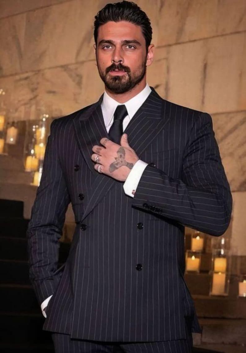 Elegant men’s custom pinstripe double breasted suit with peak lapels, tailored fit blazer, and matching trousers, designed for weddings, business, and red carpet events.