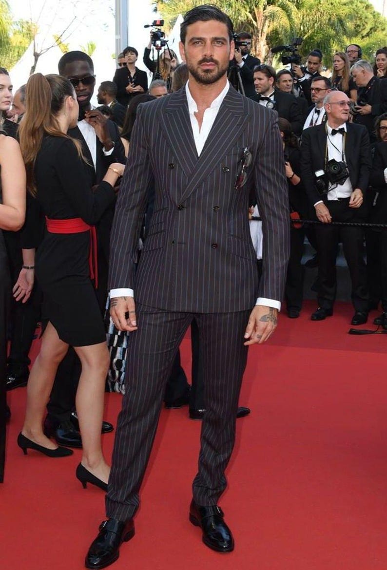 Elegant men’s custom pinstripe double breasted suit with peak lapels, tailored fit blazer, and matching trousers, designed for weddings, business, and red carpet events.