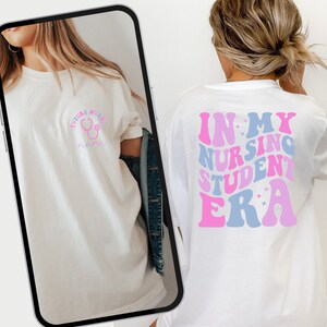May include: White t-shirt with the text "IN MY NURSING STUDENT ERA" in pink and blue retro font on the back. The front features the text "FUTURE NURSE" with a stethoscope graphic in pink and a space for a name.
