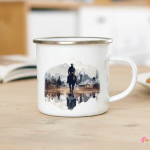Cowboy camp coffee cup with a Western print, displayed on a wooden table
