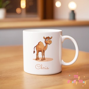 May include: White ceramic mug featuring a cartoon camel illustration and the name "Chris" printed on the front.
