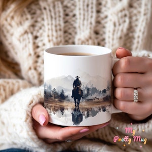 Woman holding a Cowboy coffee cup with a colorful Western design