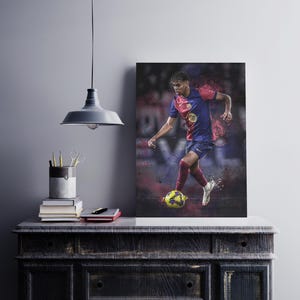 May include: A soccer player in a red and blue jersey with a yellow logo, dribbling a soccer ball. The player is wearing black shorts and white socks. The background is blurred and has a red and blue color scheme.