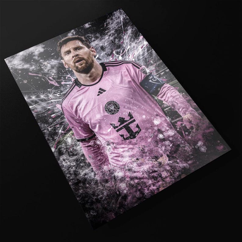 May include: A pink soccer jersey with black accents and a large anchor logo. The jersey has a white crown above the anchor and the text "Inter Miami CF" on the chest.