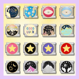 May include: A collection of silver-toned charm bracelets with various colorful designs. The charms feature celestial themes, stars, eyes, mountains, and phrases like "Good Luck" and "Go Wild". Each charm is round with a detailed illustration.