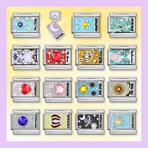 May include: A collection of silver-toned charm bracelets with colorful designs and text. Each charm features a different image, including stars, moons, and suns. The text includes words like "The Star", "The Moon", and "Emperor".