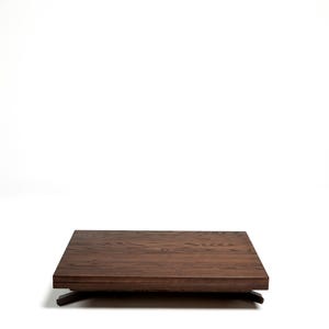 May include: A dark brown wooden coffee table with a rectangular top and a simple, modern design.