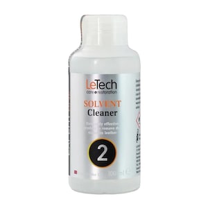 May include: A white plastic bottle of LeTech Solvent Cleaner. The label includes the text "SOLVENT Cleaner" and "Extremely effective product to remove dye stains on leather." A large number "2" is in a yellow circle. The bottle contains 100 ml.