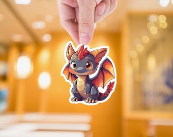 May include: A sticker featuring a cartoon illustration of a small, blue dragon with orange wings and red horns. The dragon has large, expressive eyes and a friendly expression.