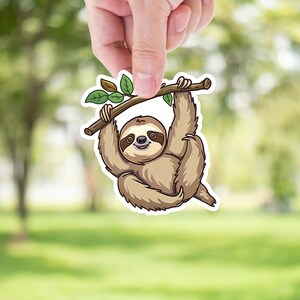May include: A cartoon sloth sticker with a brown and tan fur, hanging from a branch with green leaves. The sloth has a happy expression and is smiling.