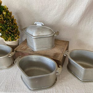 May include: A set of three ceramic mugs with a speckled, matte finish. The mugs are in shades of cream, light brown, and dark brown. Each mug has a simple, minimalist design, perfect for coffee or tea.